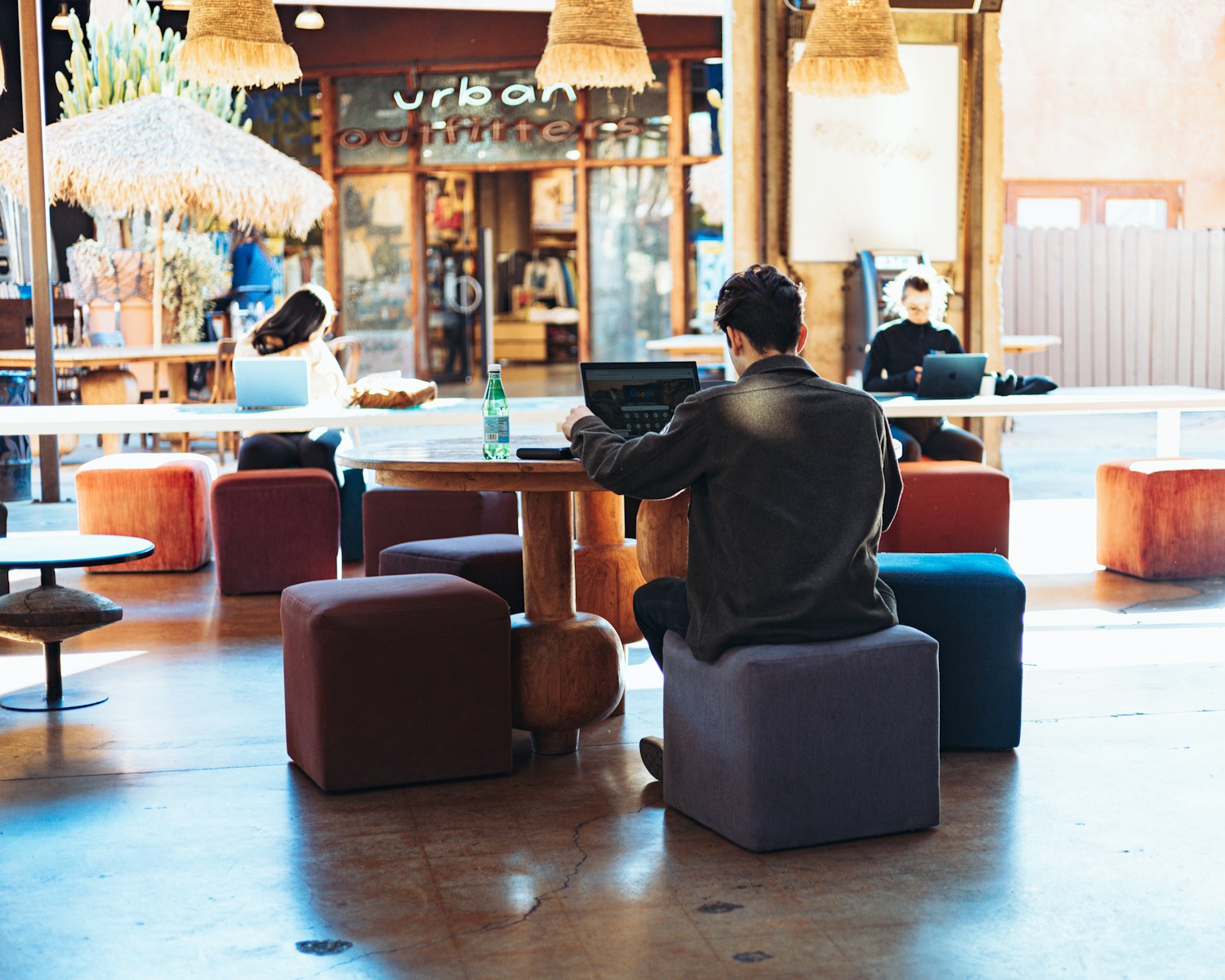 a man sitting at a table with a laptop